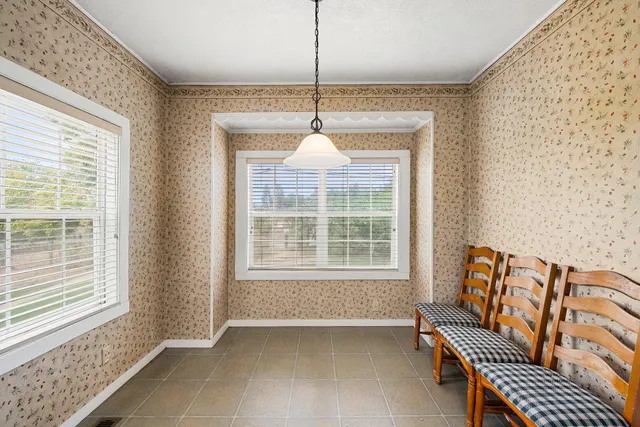 a view of a house with snow on the side of road