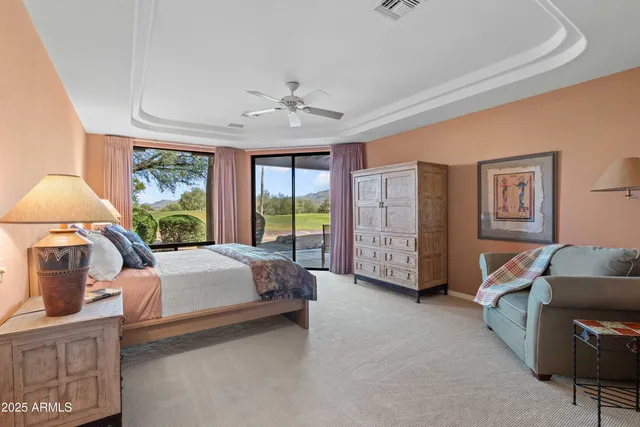 a room with a large window and a bed