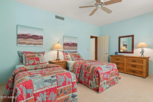 a bedroom with two beds and a window