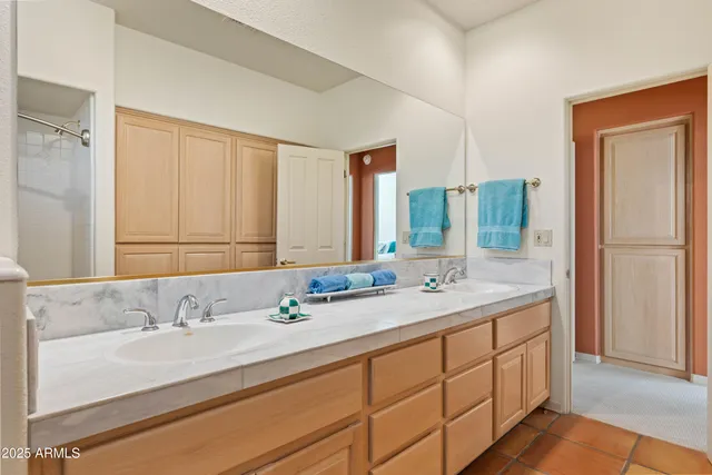 a bedroom with two beds and painting on the wall