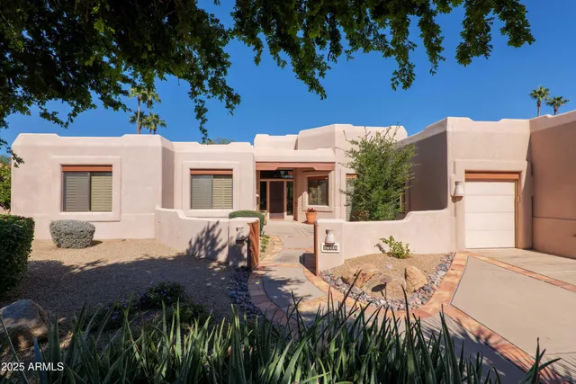 a view of house with yard and seating area