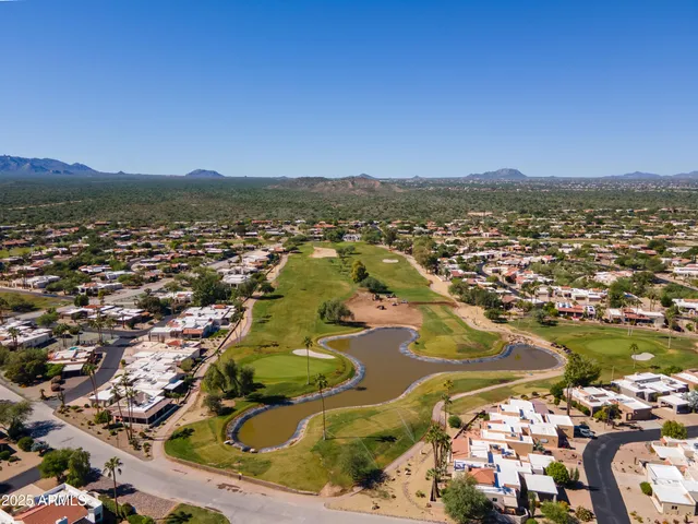an aerial view of residential houses with outdoor space