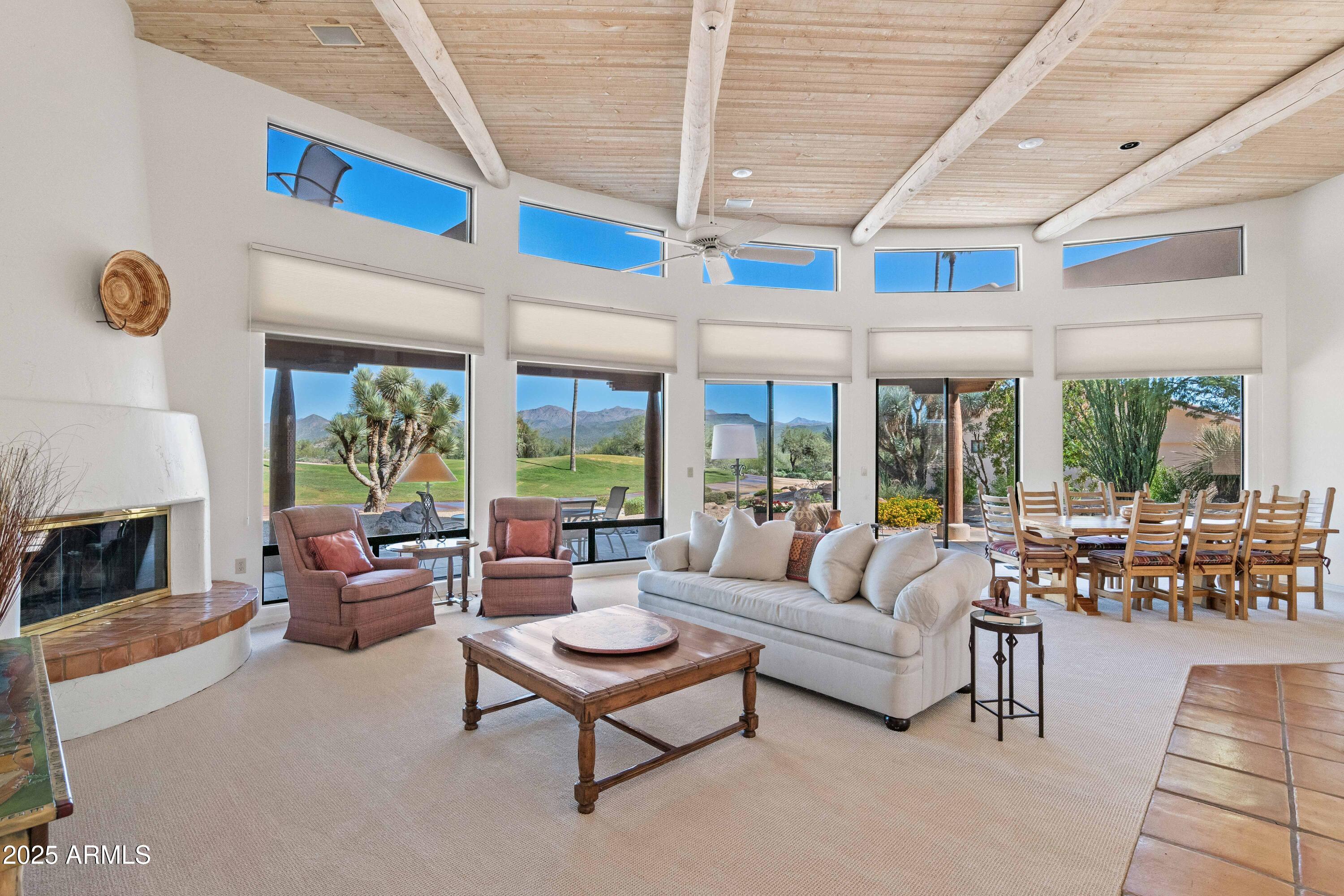 19130 East Alondra Way Rio Verde, AZ 85263 - Photo 40 of 40 a living room with furniture a fireplace and floor to ceiling windows