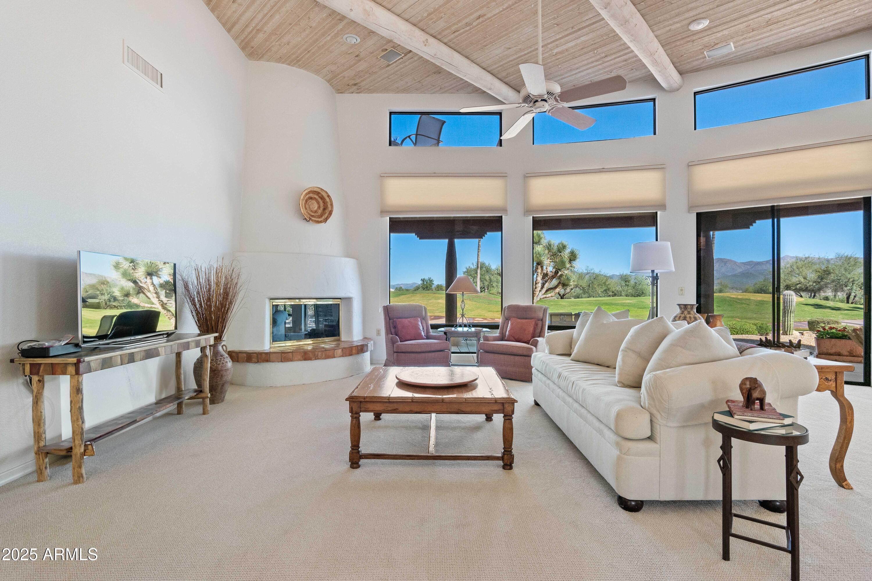 19130 East Alondra Way Rio Verde, AZ 85263 - Photo 3 of 40 a living room with furniture fireplace and flat screen tv