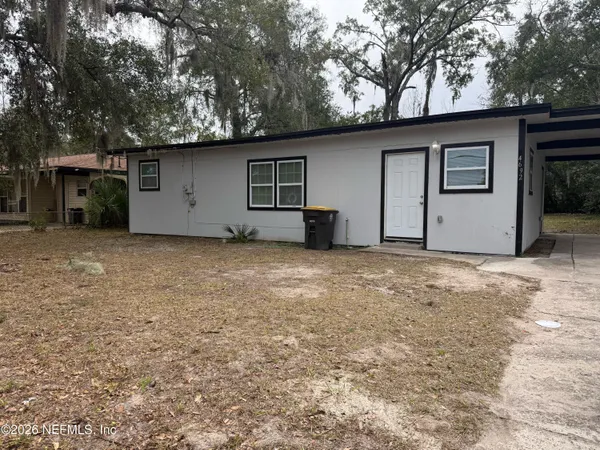 a house that has a tree in front of it