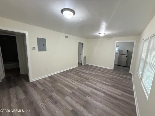 wooden floor in an empty room with a window