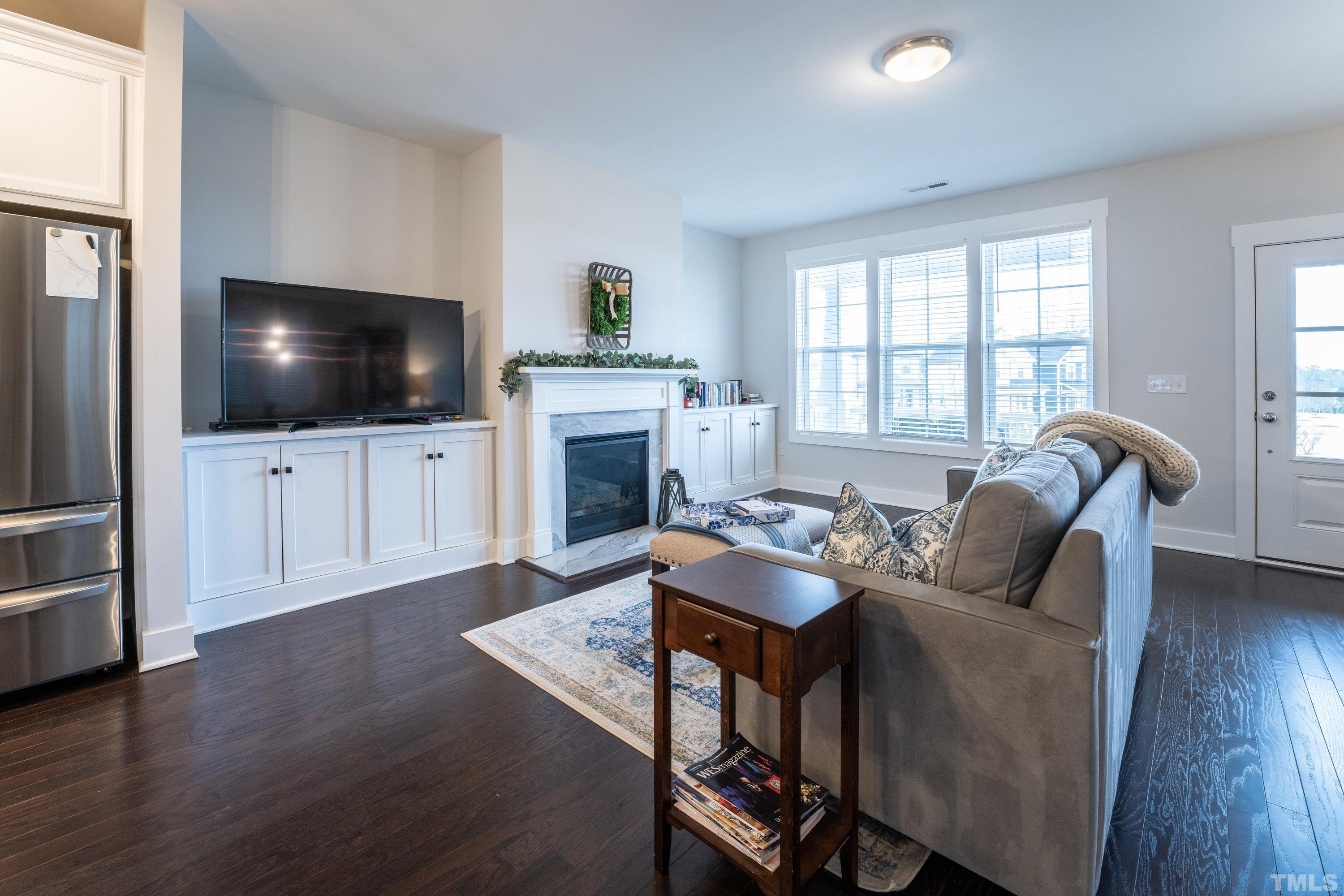 272 Daniel Ridge Road Wendell, NC 27591 - Photo 11 of 39 a living room with furniture and a flat screen tv