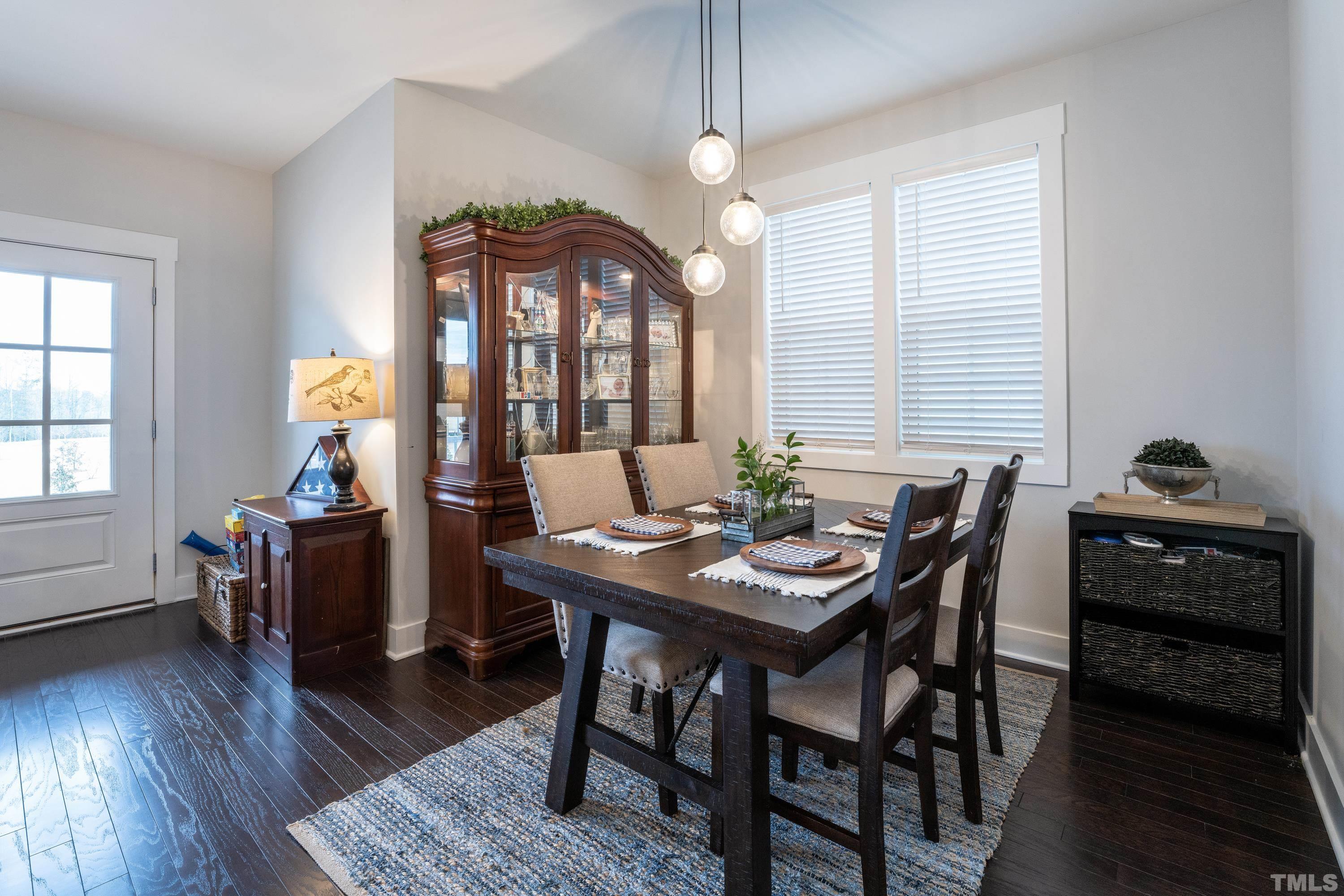272 Daniel Ridge Road Wendell, NC 27591 - Photo 12 of 39 a view of a dining room with furniture window and wooden floor