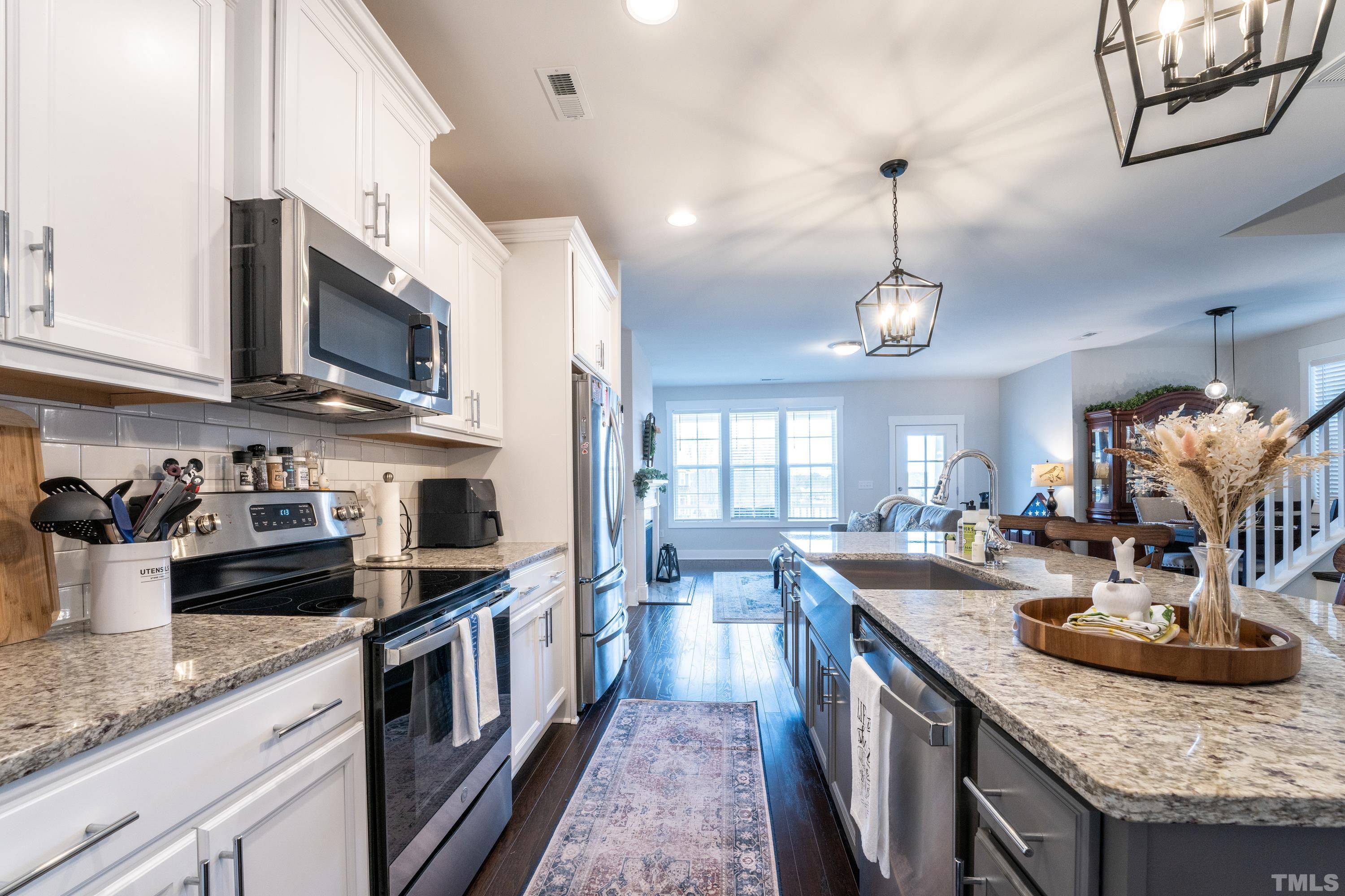 272 Daniel Ridge Road Wendell, NC 27591 - Photo 19 of 39 a kitchen with stainless steel appliances granite countertop a sink a stove and cabinets