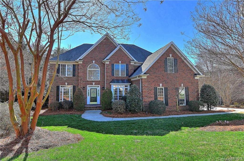 3203 Planters Ridge Road Charlotte, NC 28270 - Photo 1 of 36 a front view of a house with a garden and trees