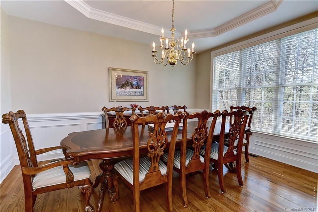 3203 Planters Ridge Road Charlotte, NC 28270 - Photo 15 of 36 a view of a dining room with furniture wooden floor and chandelier