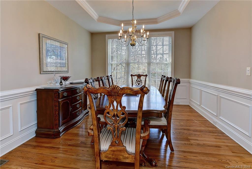 3203 Planters Ridge Road Charlotte, NC 28270 - Photo 16 of 36 a view of a dining room with furniture wooden floor and chandelier