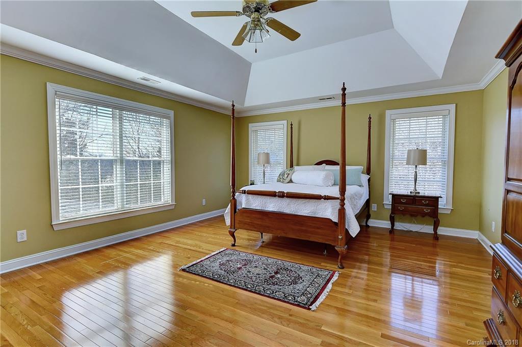 3203 Planters Ridge Road Charlotte, NC 28270 - Photo 18 of 36 a bedroom with a bed and wooden floor