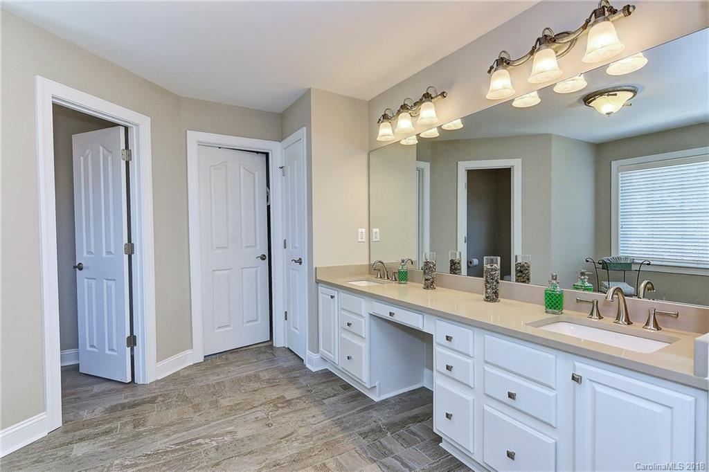 3203 Planters Ridge Road Charlotte, NC 28270 - Photo 20 of 36 a spacious en suite bathroom with double sink and a mirror