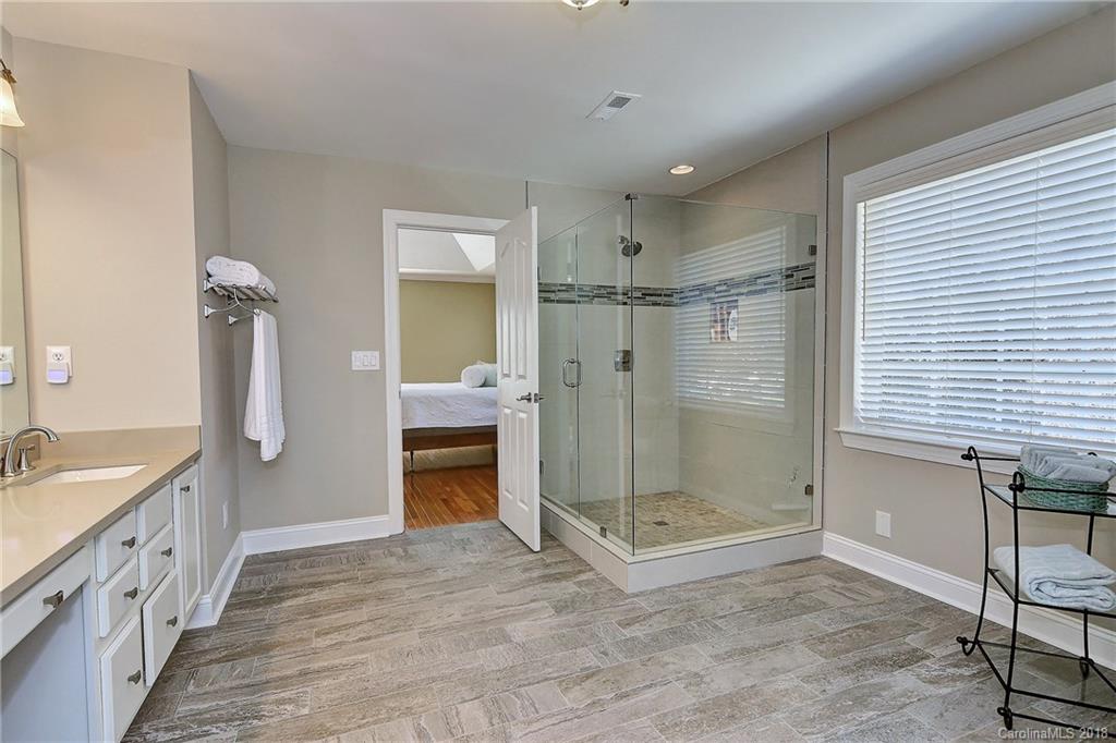 3203 Planters Ridge Road Charlotte, NC 28270 - Photo 21 of 36 a bathroom with a shower sink and mirror