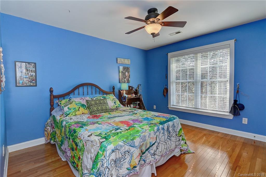 3203 Planters Ridge Road Charlotte, NC 28270 - Photo 23 of 36 a bedroom with a bed and a chandelier