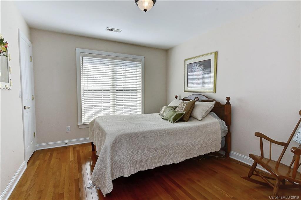3203 Planters Ridge Road Charlotte, NC 28270 - Photo 25 of 36 a bedroom with a bed and wooden floor