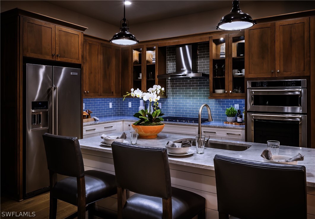 14831 Loggerhead Drive Naples, FL 34120 - Photo 3 of 10 a kitchen with granite countertop a sink stainless steel appliances and cabinets