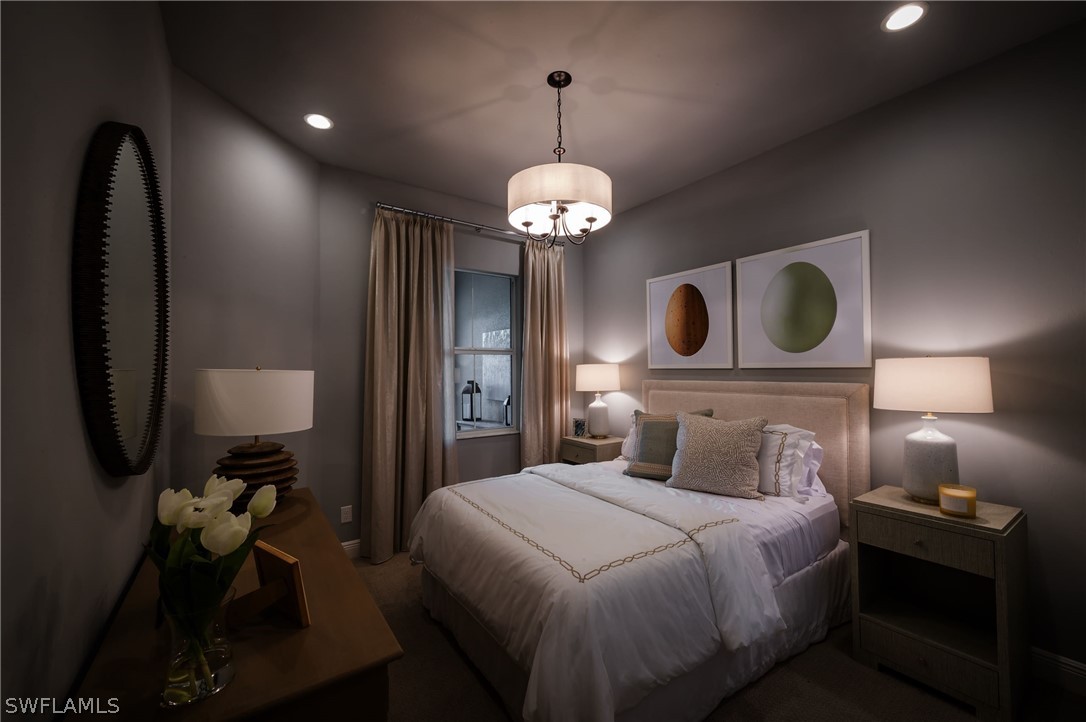 14831 Loggerhead Drive Naples, FL 34120 - Photo 4 of 10 a bedroom with a bed and a chandelier
