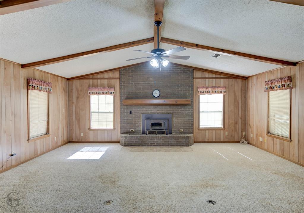 314 Dilly Road Mooringsport, LA 71060 - Photo 26 of 37 Large living room with vaulted ceiling. Wood burning fireplace/heatilator