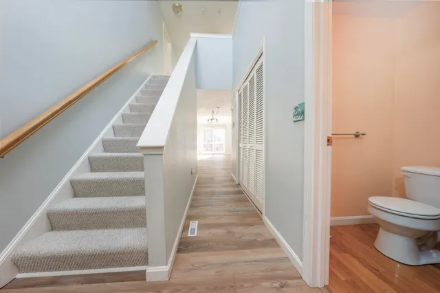 a view of a hallway with wooden floor and entryway