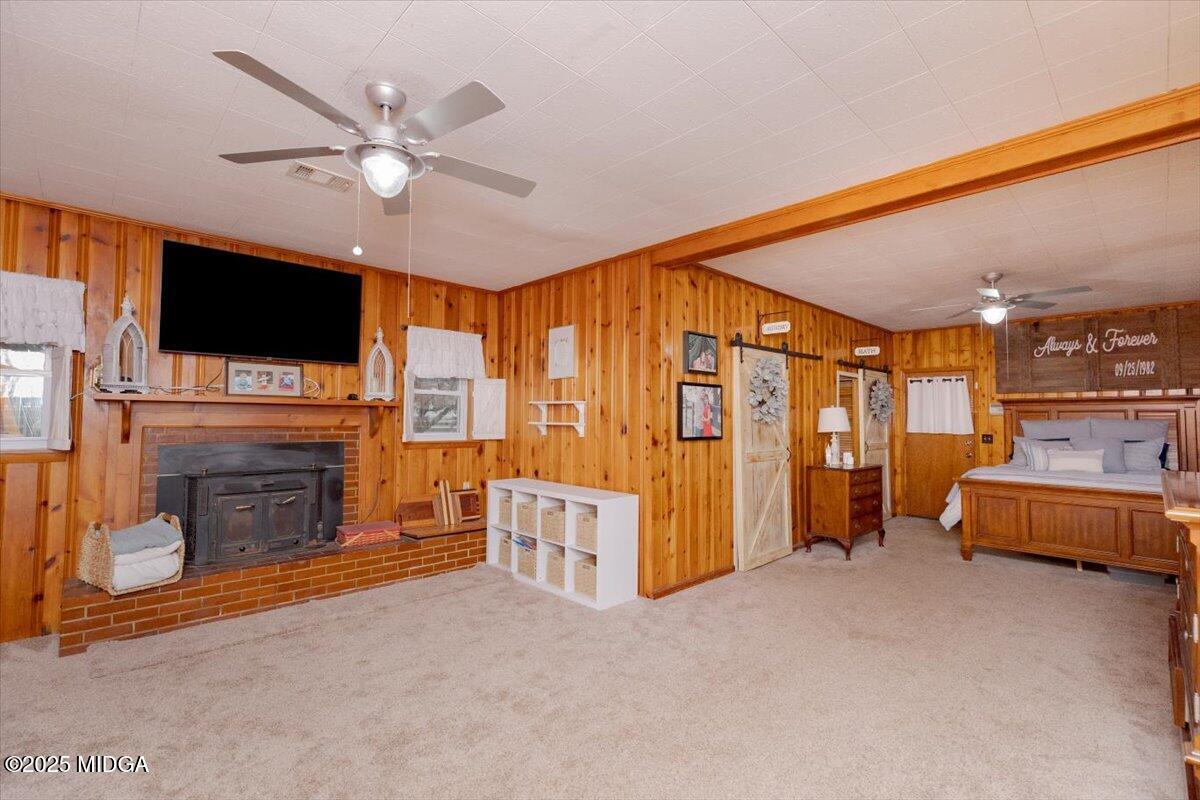 150 Moss Oaks Road Perry, GA 31069 - Photo 22 of 51 a living room with furniture a flat screen tv and a fireplace