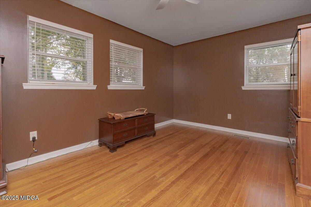 150 Moss Oaks Road Perry, GA 31069 - Photo 33 of 51 a room with wooden floor and window
