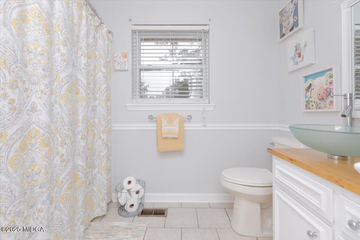 150 Moss Oaks Road Perry, GA 31069 - Photo 37 of 51 a bathroom with a toilet a sink and a window