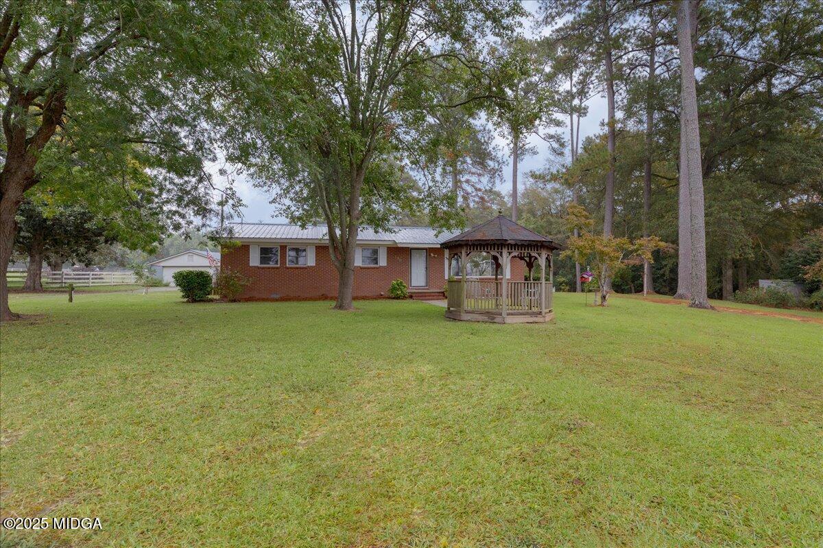 150 Moss Oaks Road Perry, GA 31069 - Photo 4 of 51 a view of a house with a yard patio and tree