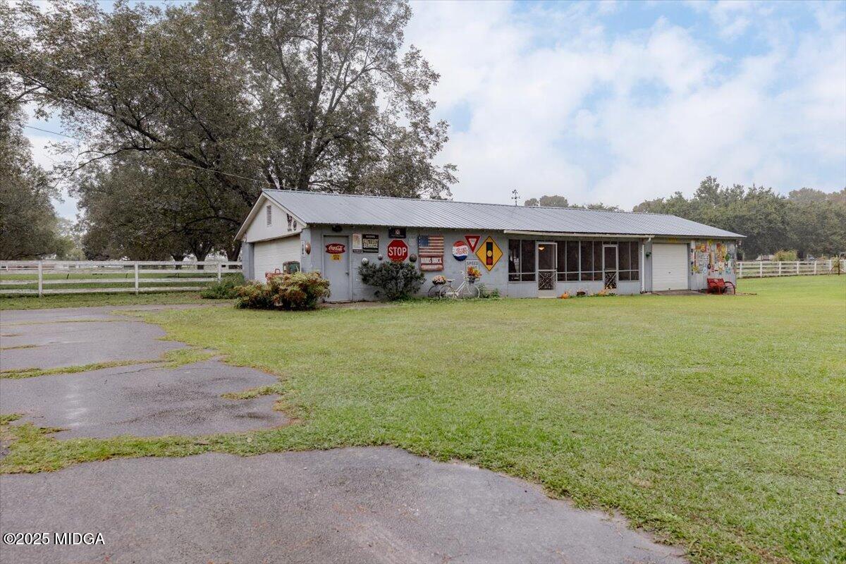 150 Moss Oaks Road Perry, GA 31069 - Photo 47 of 51 a view of a house with garden and trees in the background