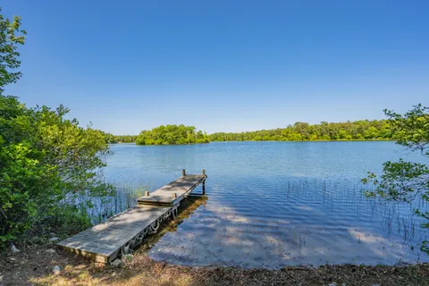 a view of a lake with houses in the back