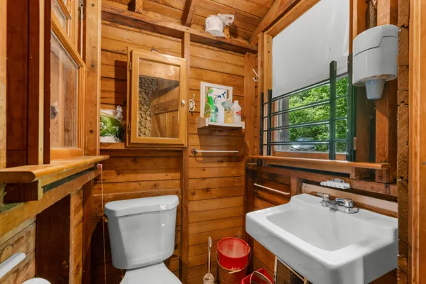 a bathroom with a toilet sink and mirror