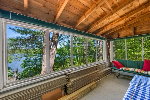a room with large windows and wooden floor