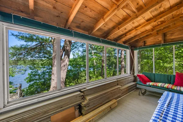 a room with large windows and wooden floor
