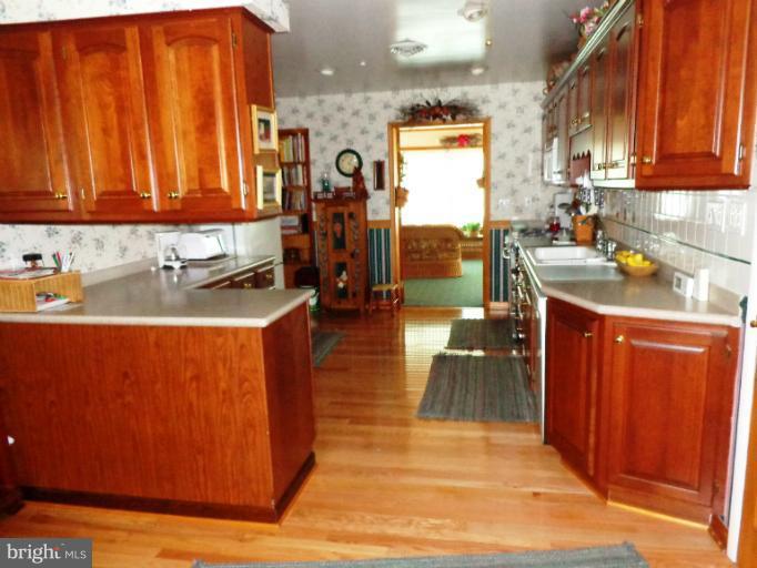 1829 Clear View Road Union Bridge, MD 21791 - Photo 5 of 20 a kitchen with stainless steel appliances granite countertop wooden cabinets a sink and a counter space