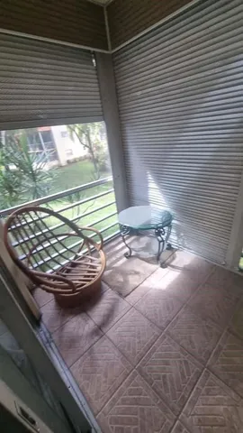 a view of a room with wooden floor and a floor to ceiling window