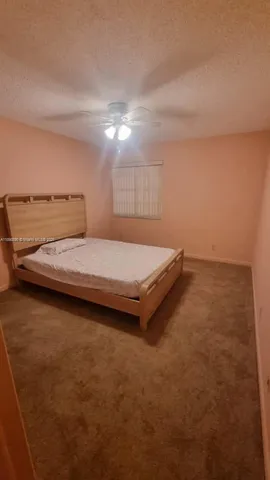 a bedroom with a bed and a night stand