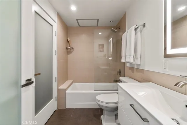 a bathroom with a toilet and a mirror