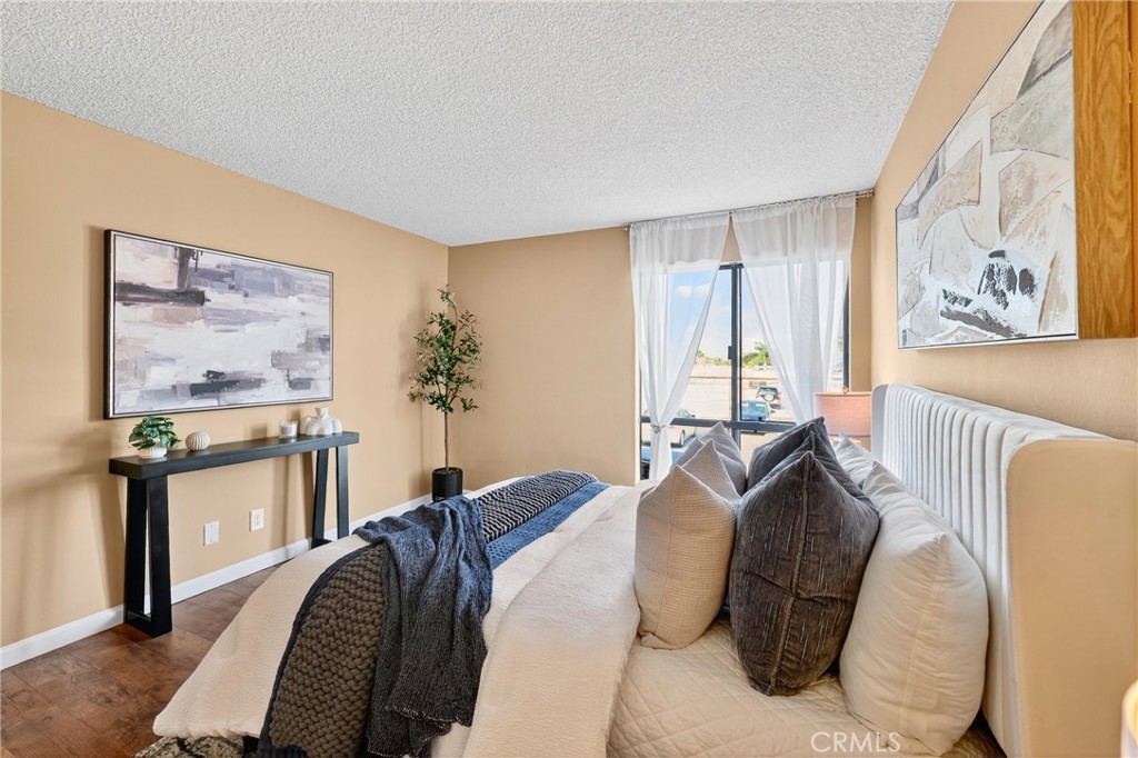 5585 Pacific Coast Highway, Unit 161 Long Beach, CA 90804 - Photo 13 of 44 a bed sitting in a bedroom next to a window
