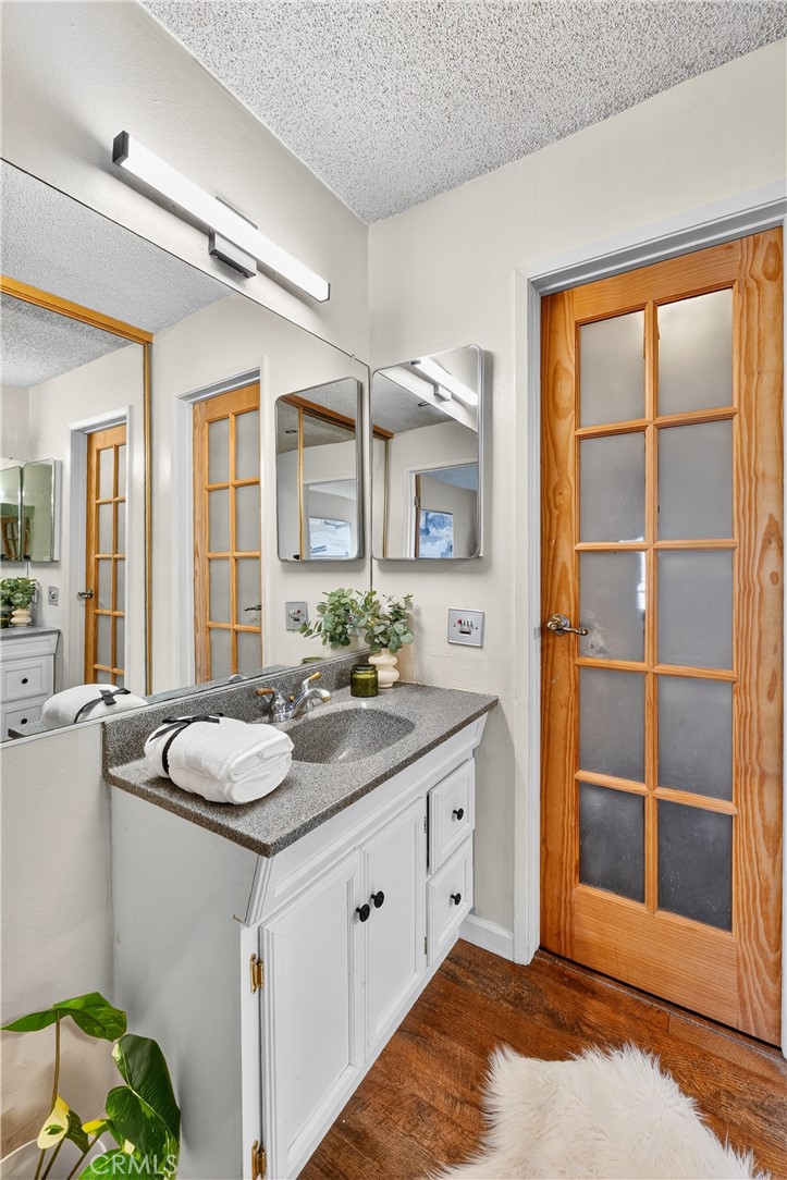 5585 Pacific Coast Highway, Unit 161 Long Beach, CA 90804 - Photo 16 of 44 a spacious bathroom with a granite countertop sink and a mirror