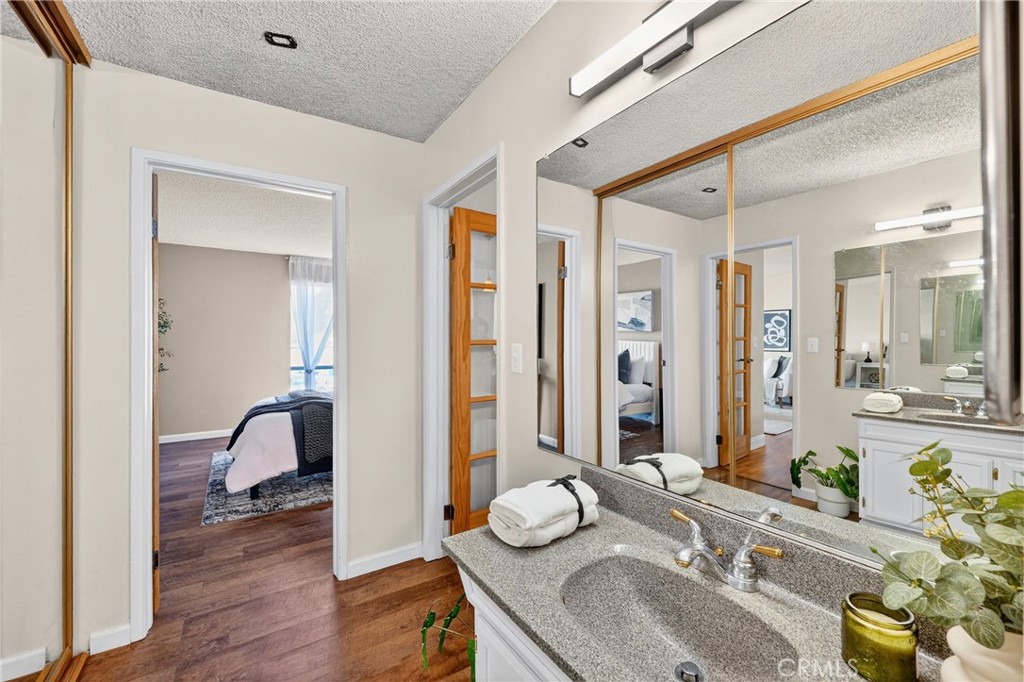 5585 Pacific Coast Highway, Unit 161 Long Beach, CA 90804 - Photo 18 of 44 a bathroom with a granite countertop sink and a mirror