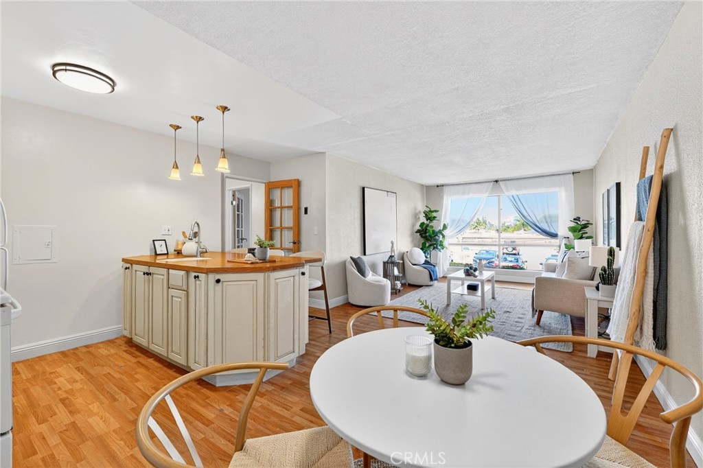 5585 Pacific Coast Highway, Unit 161 Long Beach, CA 90804 - Photo 2 of 44 a view of a dining room with furniture window and wooden floor