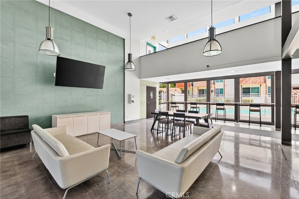 5585 Pacific Coast Highway, Unit 161 Long Beach, CA 90804 - Photo 28 of 44 a living room with furniture a flat screen tv and a large window
