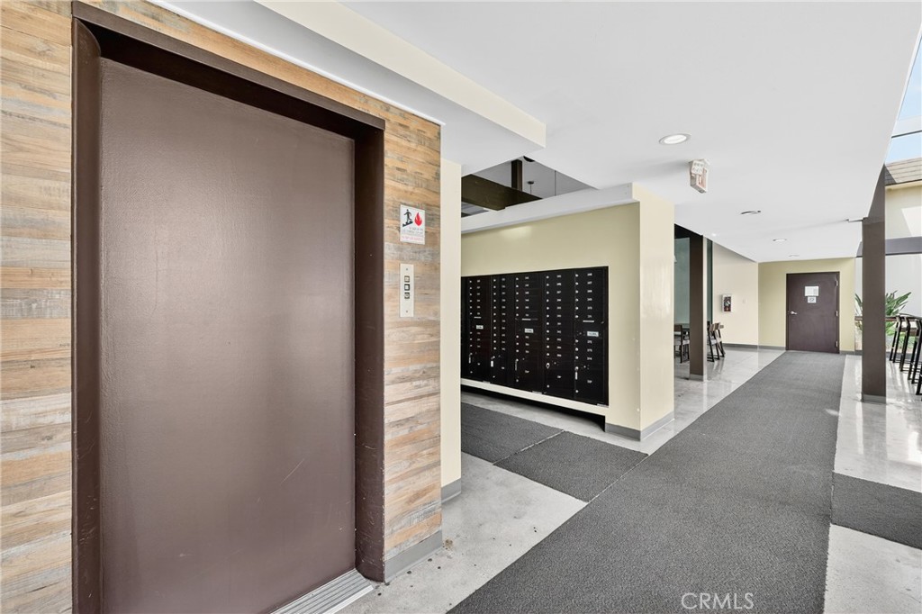 5585 Pacific Coast Highway, Unit 161 Long Beach, CA 90804 - Photo 35 of 44 a view of a hallway with wooden shelves and fireplace