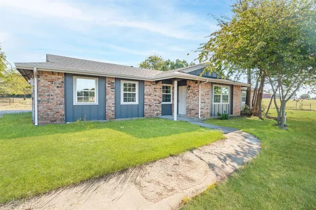 front view of a house with a yard