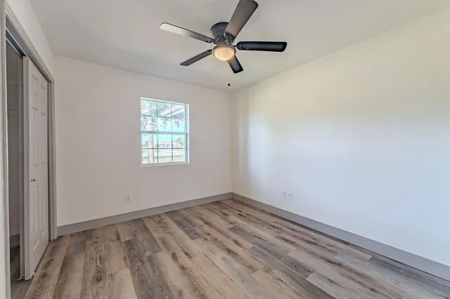 wooden floor in an empty room with a window