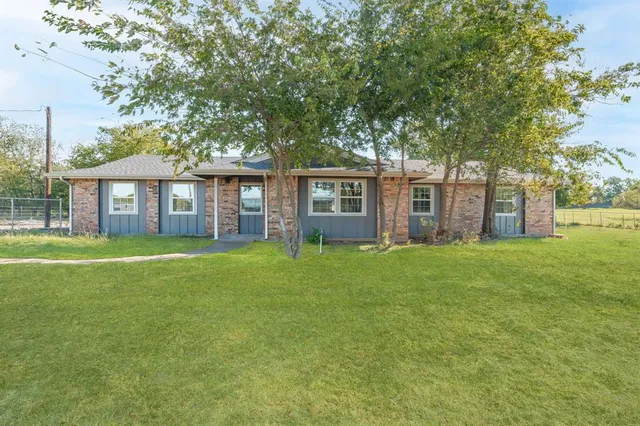 a front view of a house with a garden and porch