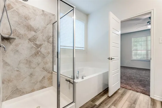 a bathroom with a double vanity sink a mirror and a shower