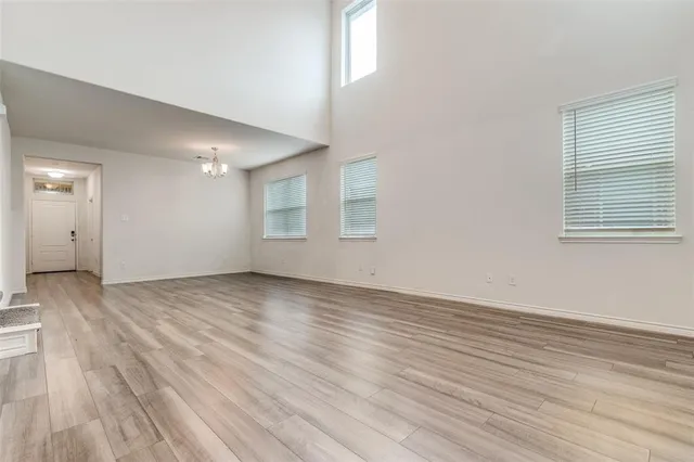 a kitchen that has a sink a stove and wooden floor