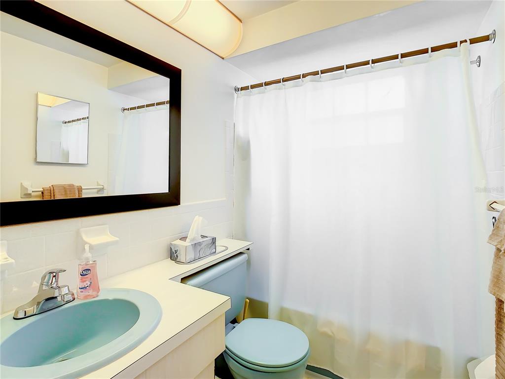 4230 Redcliff Place, Unit 4230 New Port Richey, FL 34652 - Photo 25 of 42 a bathroom with a sink a toilet and shower curtain
